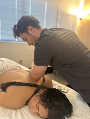Lady is receiving massage therapy which calms the nervous system and helps to relieve pain