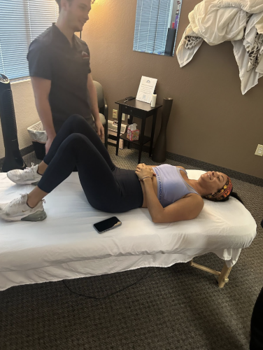Lady on massage table is relieved of chronic pain after massage therapy