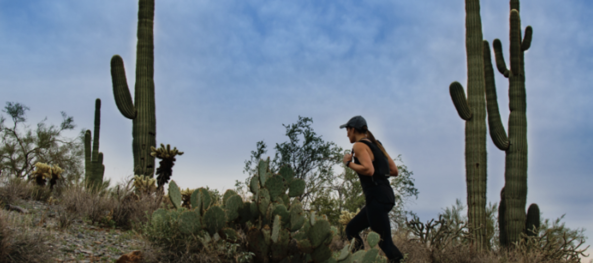A girl is staying active by hiking in Arizona despite the hot weather by training in the early morning.