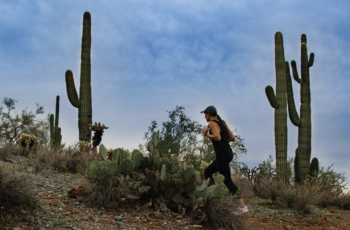 A girl is staying active by hiking in Arizona despite the hot weather by training in the early morning.