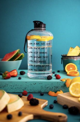 Water bottle to keep you hydrated as you exercise along with fruits that provide vitamins and other essential nutrients.