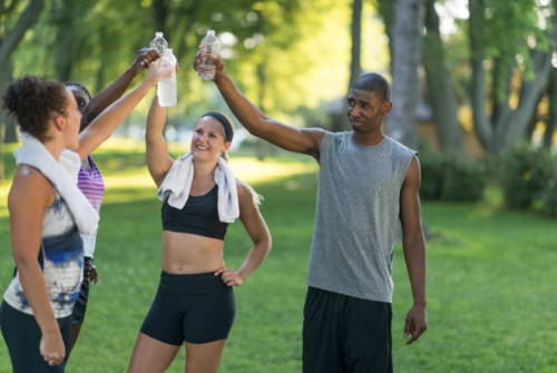 A group of friends rehydrating themselves after an outdoor workout